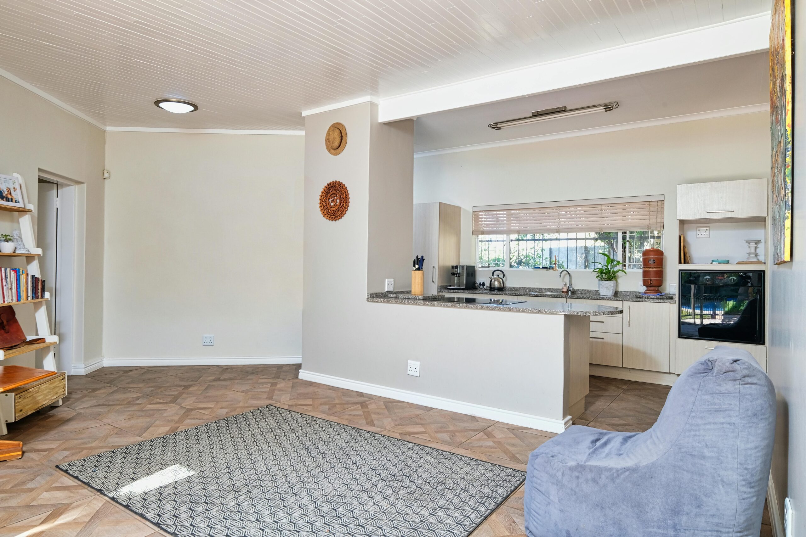 Spacious modern kitchen and living area with minimalist decor and natural light.
